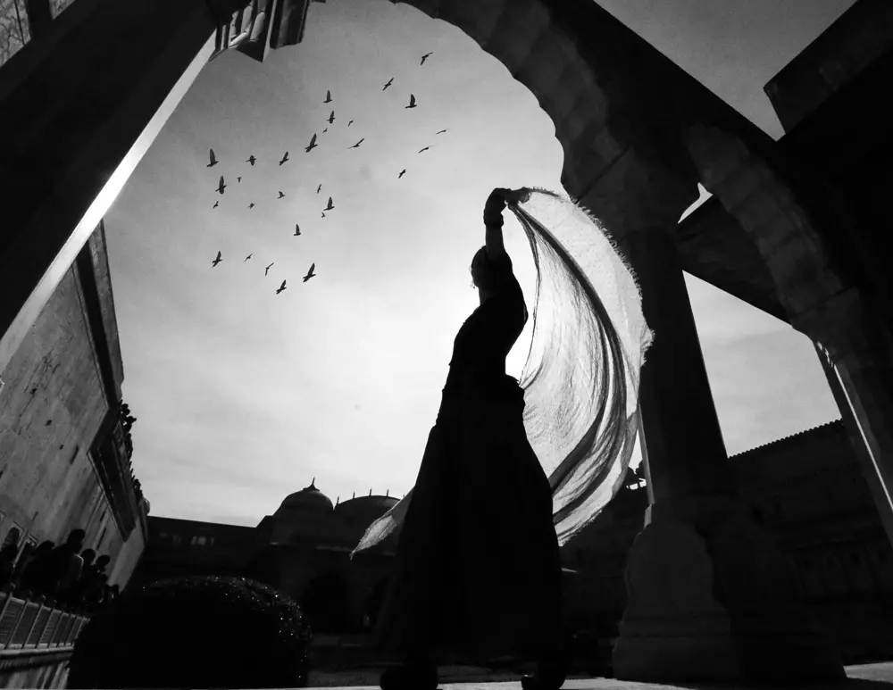 Silhouette of a bride in a flowing gown