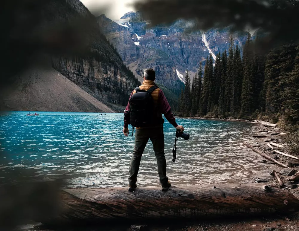 Photographer taking pictures on a riverbank